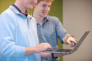 two young men looking at laptop
