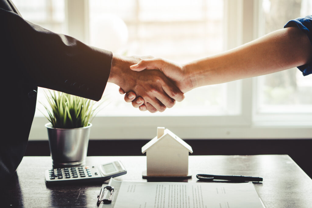 homeowner shaking hands with real estate agent or broker