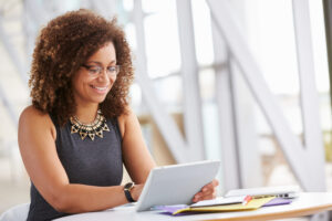 young African American woman working with tablet in office