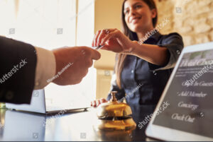 guest takes room key card at check in desk at a hotel close up