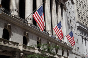 American flags hang from a building on Wall Street
